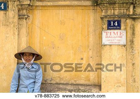 Woman resting on a wall, Hanoi, Vietnam. View Large Photo Image Stock Photography - Woman resting on a wall, Hanoi, Vietnam.. Fotosearch