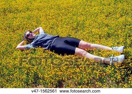Woman resting on the grass, Villagordo del Jucar, Albacete, Castilla-La Mancha, Spain View Large Photo Image Stock Image - Woman resting on the grass, Villagordo del Jucar, Albacete, Castilla-La Mancha, Spain. Fotosearch