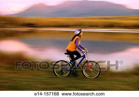 Woman riding mountain bike. Alaska. USA View Large Photo Image Stock Photo - Woman riding mountain bike. Alaska. USA. Fotosearch