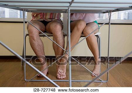 woman rubbing foot against businessman's leg, low section View Large Photo Image Stock Photo - woman rubbing foot against businessman's leg, low section. Fotosearch