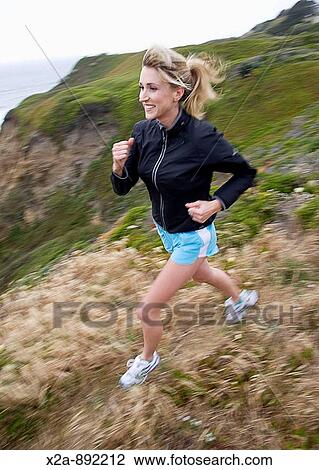 WOMAN RUNNING ALONG PACIFIC OCEAN CLIFFS View Large Photo Image Stock Image - WOMAN RUNNING ALONG PACIFIC OCEAN CLIFFS. Fotosearch