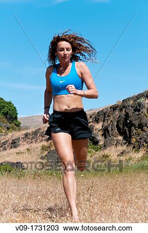 Woman running barefoot View Large Photo Image Stock Image - Woman running barefoot. Fotosearch