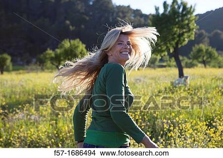 Woman running in a meadow View Large Photo Image Picture - Woman running in a meadow. Fotosearch