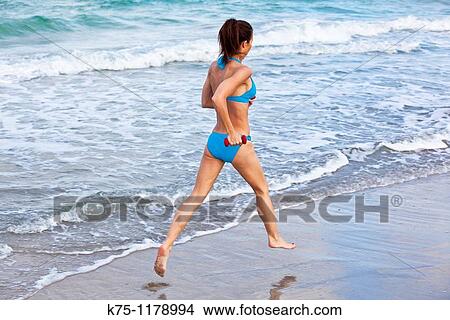 Woman running on beach View Large Photo Image Picture - Woman running on beach. Fotosearch