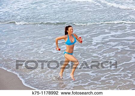 woman running on beach View Large Photo Image Stock Image - woman running on beach. Fotosearch