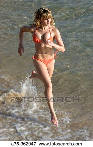 Woman running on beach View Large Photo Image Stock Photo - Woman running on beach. Fotosearch