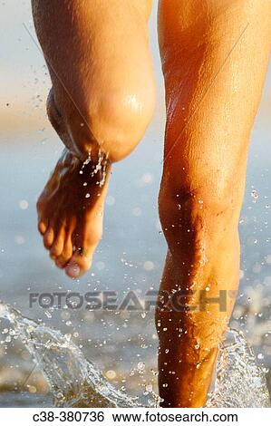 Woman running on beach View Large Photo Image Stock Photograph - Woman running on beach. Fotosearch