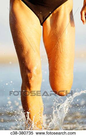Woman running on beach View Large Photo Image Stock Photography - Woman running on beach. Fotosearch