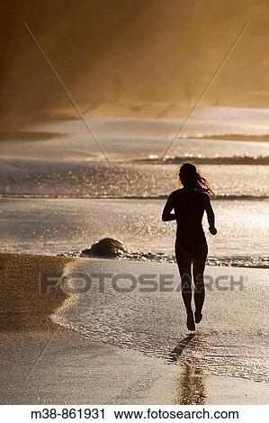 Woman running on the beach Maui, Hawaii View Large Photo Image Stock Image - Woman running on the beach Maui, Hawaii. Fotosearch