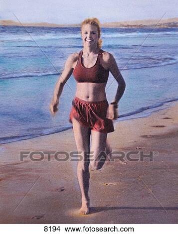 Picture - Woman running on the beach. Fotosearch