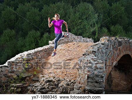 Woman running over a old bridge. Puente Saladillo, Tarifa, Costa de la Luz, Cadiz, Andalusia, Spain, Europe. View Large Photo Image Stock Photography - Woman running over a old bridge. Puente Saladillo, Tarifa, Costa de la Luz, Cadiz, Andalusia, Spain, Europe.. Fotosearch