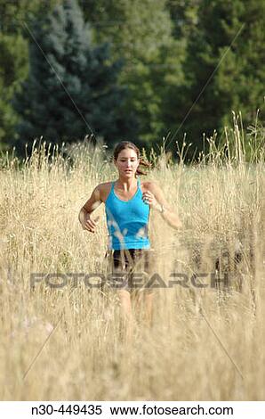 Woman running through field View Large Photo Image Stock Photography - Woman running through field. Fotosearch