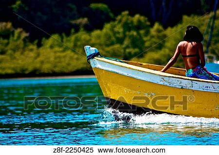 Woman sailing on a wooden boat in Baia de Todos os Santos, Salvador, Bahia, Brazil. View Large Photo Image Stock Photography - Woman sailing on a wooden boat in Baia de Todos os Santos, Salvador, Bahia, Brazil.. Fotosearch