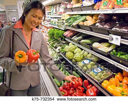 Woman selecting peppers in supermarket View Large Photo Image Picture - Woman selecting peppers in supermarket. Fotosearch