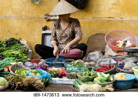 Woman selling fruits and vegetables on the street market in old Hanoi city. View Large Photo Image Stock Image - Woman selling fruits and vegetables on the street market in old Hanoi city.. Fotosearch