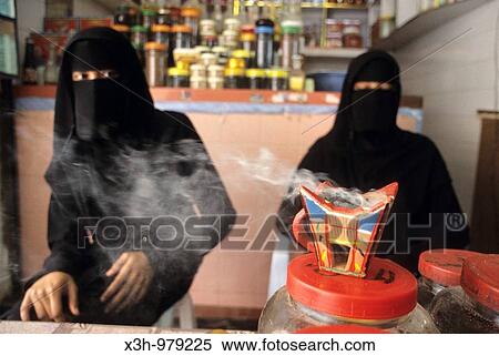 Stock Photography - woman selling incense in souk of Salalah, Dhofar, Sultanate of Oman, Arabian Peninsula, southwest Asia. Fotosearch