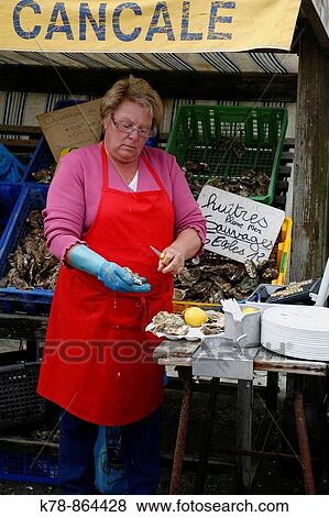 Woman selling oysters at the market by the prot in Cancale, Brittany, France View Large Photo Image Stock Photo - Woman selling oysters at the market by the prot in Cancale, Brittany, France. Fotosearch