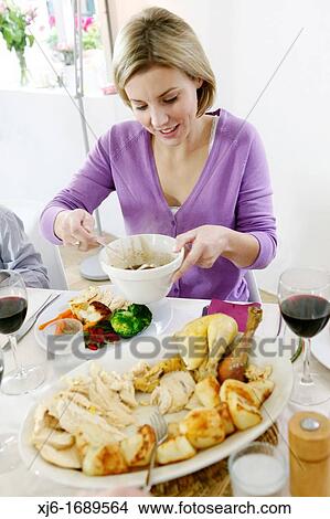 Woman serving dinner View Large Photo Image Picture - Woman serving dinner. Fotosearch