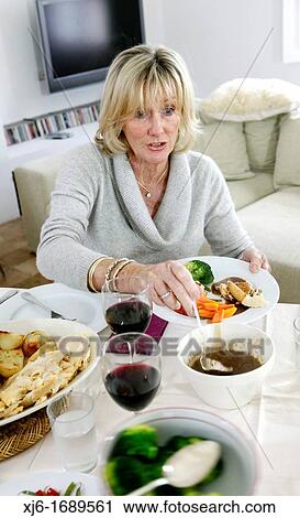 Woman serving dinner View Large Photo Image Stock Image - Woman serving dinner. Fotosearch