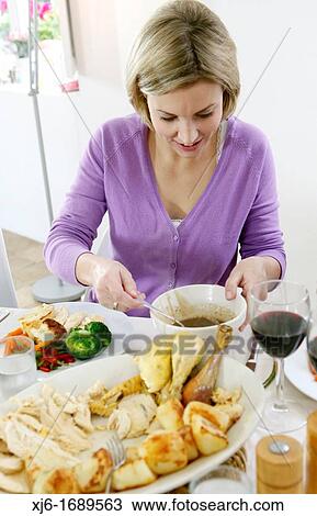 Woman serving dinner View Large Photo Image Stock Image - Woman serving dinner. Fotosearch