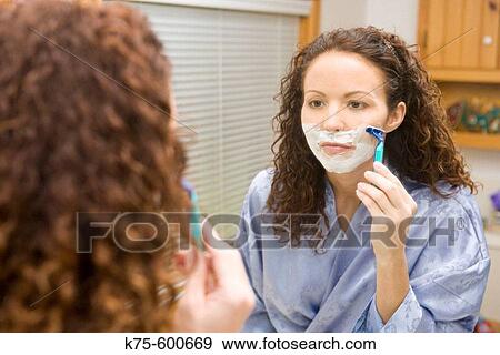 Stock Photo - Woman shaving face. Fotosearch