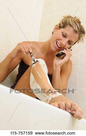 Stock Photo - woman shaving in bath. Fotosearch