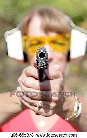 Woman shooting a 45 auto at targets View Large Photo Image Stock Photo - Woman shooting a 45 auto at targets. Fotosearch