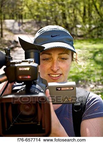 Picture - Woman shooting with video camera. Fotosearch