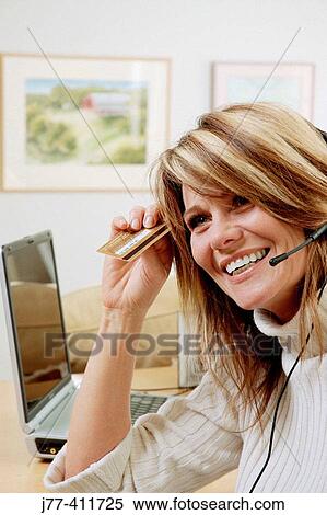 Woman shopping by phone, credit card in hand View Large Photo Image Stock Photography - Woman shopping by phone, credit card in hand. Fotosearch