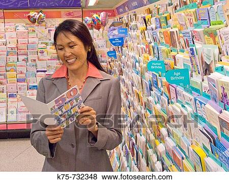 Woman shopping for greeting card View Large Photo Image Stock Photo - Woman shopping for greeting card. Fotosearch