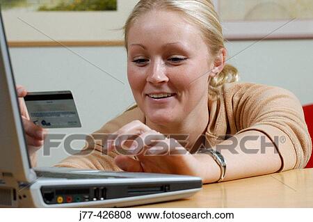 Stock Photo - Woman shopping on line.. Fotosearch