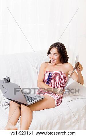 Stock Image - Woman showing by cam the radiograph. Fotosearch