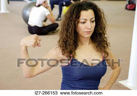 Woman showing muscles View Large Photo Image Stock Image - Woman showing muscles. Fotosearch