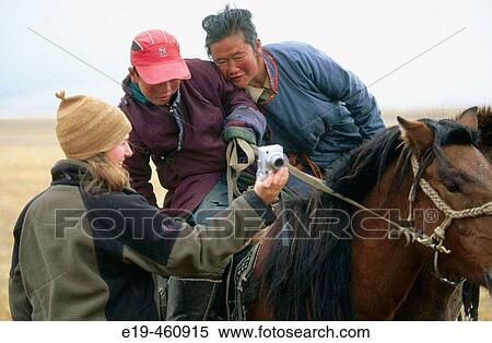 Woman showing nomads digital pictures, Mongolia View Large Photo Image Stock Photography - Woman showing nomads digital pictures, Mongolia. Fotosearch
