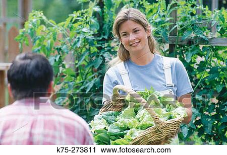 Woman showing off basket of greens View Large Photo Image Stock Image - Woman showing off basket of greens. Fotosearch