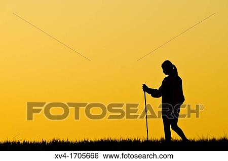Woman silhouette make trekking in countryside View Large Photo Image Stock Photograph - Woman silhouette make trekking in countryside. Fotosearch