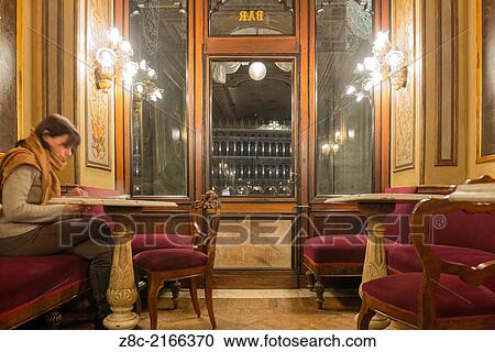 Woman sitting and reading in the oldest cafe in Italy from 1720, Venice Italy View Large Photo Image Stock Image - Woman sitting and reading in the oldest cafe in Italy from 1720, Venice Italy. Fotosearch
