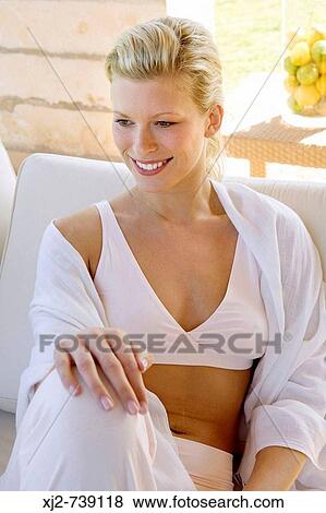 Stock Photo - Woman sitting at home. Fotosearch