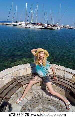 Woman sitting in Naxos port, Cyclades Islands, Greece View Large Photo Image Stock Photo - Woman sitting in Naxos port, Cyclades Islands, Greece. Fotosearch