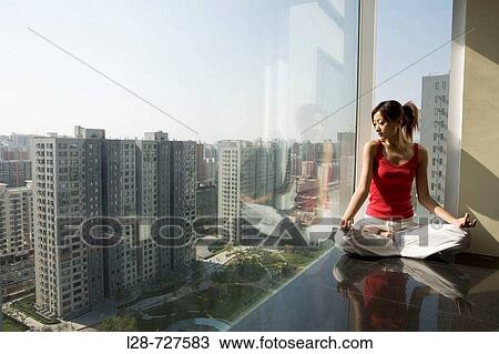 Woman sitting in yoga position on floor View Large Photo Image Stock Image - Woman sitting in yoga position on floor. Fotosearch