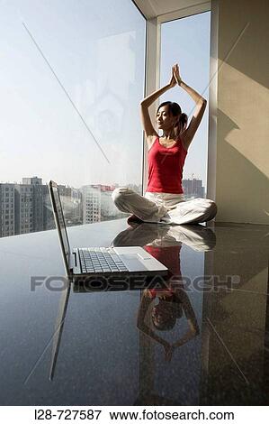 Woman sitting in yoga position on floor View Large Photo Image Stock Photo - Woman sitting in yoga position on floor. Fotosearch