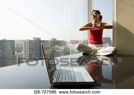 Woman sitting in yoga position on floor View Large Photo Image Stock Photograph - Woman sitting in yoga position on floor. Fotosearch
