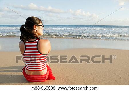 Woman sitting on a beach in Kauai. USA View Large Photo Image Stock Image - Woman sitting on a beach in Kauai. USA. Fotosearch