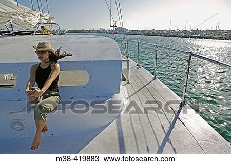Woman sitting on a catamaran while sailing in Key West, Florida. December 2004. View Large Photo Image Stock Image - Woman sitting on a catamaran while sailing in Key West, Florida. December 2004.. Fotosearch