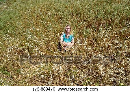 Woman sitting on a field of Naxos, Cyclades Islands, Greece View Large Photo Image Stock Image - Woman sitting on a field of Naxos, Cyclades Islands, Greece. Fotosearch