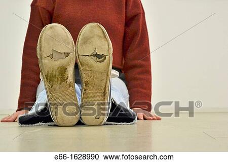 woman sitting on floor, wearing worn out sneakers View Large Photo Image Stock Image - woman sitting on floor, wearing worn out sneakers. Fotosearch