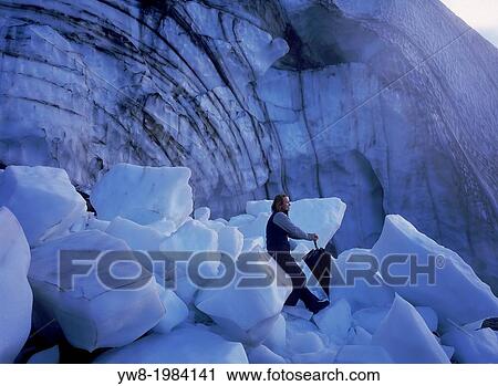 Woman sitting on ice in front of glacial Ice Cave, Hrafntinnusker, Iceland. View Large Photo Image Stock Image - Woman sitting on ice in front of glacial Ice Cave, Hrafntinnusker, Iceland.. Fotosearch