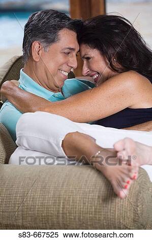Woman sitting on mans lap on the livingroom couch View Large Photo Image Stock Photography - Woman sitting on mans lap on the livingroom couch. Fotosearch