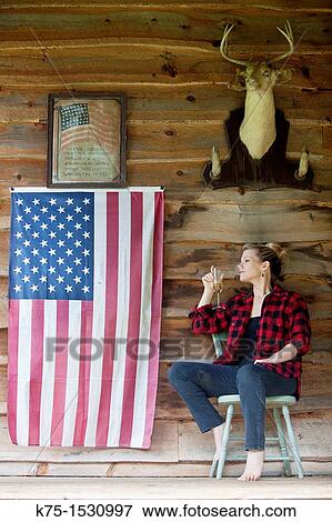 Woman sitting on porch drinking champagne View Large Photo Image Stock Photo - Woman sitting on porch drinking champagne. Fotosearch
