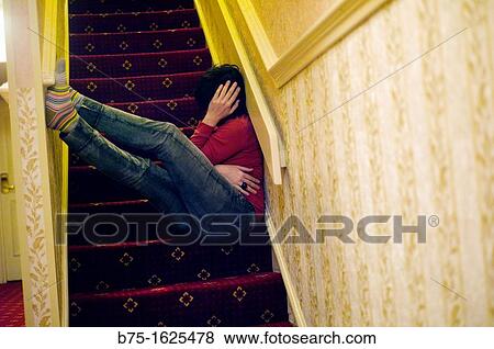 Stock Photo - Woman sitting on stairs. Fotosearch